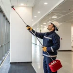 Technician performing fire alarm testing services on a commercial system in Greenville SC.