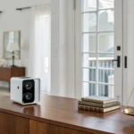A balance scale weighing a home security camera to decide if home security systems are worth it.
