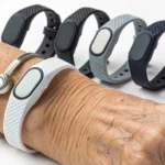 A senior wearing a fall detection bracelet, with a selection of other top-rated models.